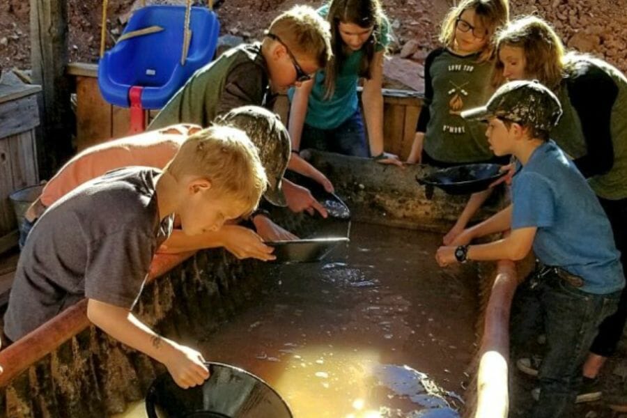 Kids enjoying the interactive tour at Gold King Mine Ghost Town where they get to do gold panning