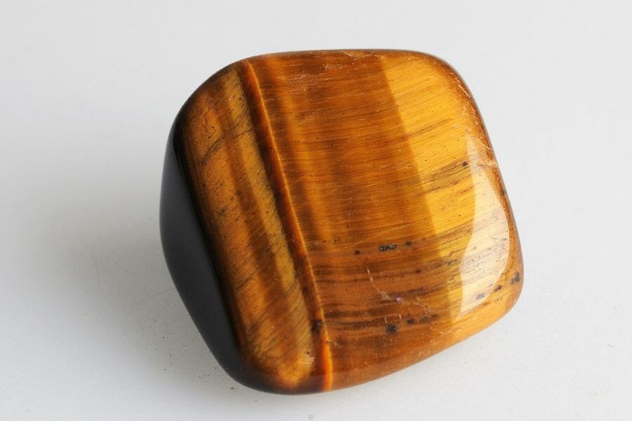 A smooth, shiny brown Tiger's Eye with fine lines of darker browns and black