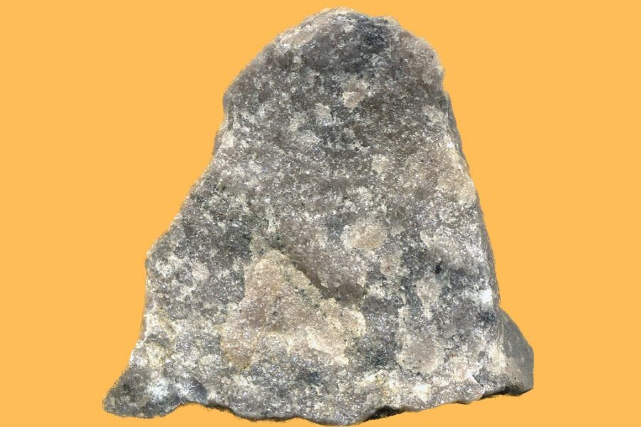 A large gray Quartzite against a yellow orange background