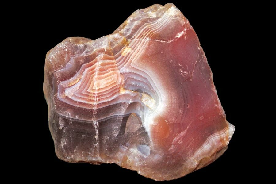An red Agate with white detailed lining against a black background