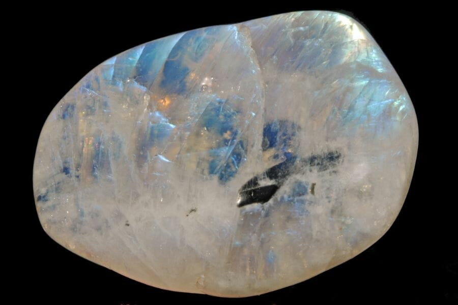 A shiny, round Moonstone against a black background