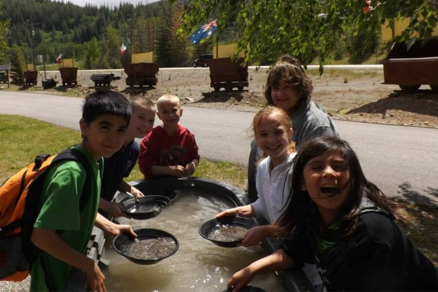 Children smiling as they pan for Gold and gemstones at the Crystal Gold Mine