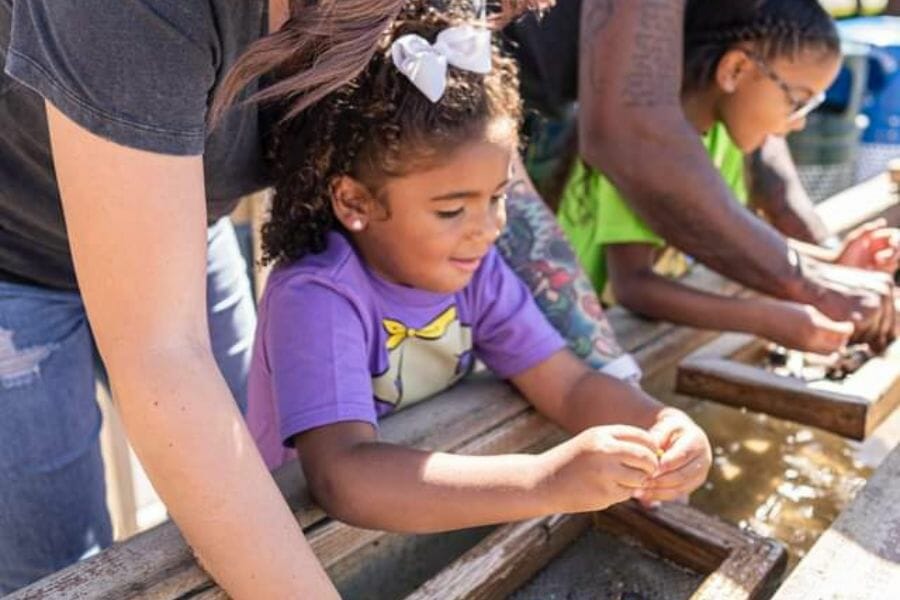 Kids trying gem panning at the Prehistoric Park of Cajun Palms RV Resort