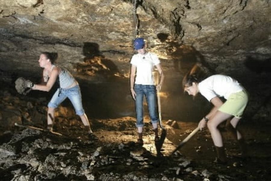Three people digging for gems at Maquoketa Caves State Park