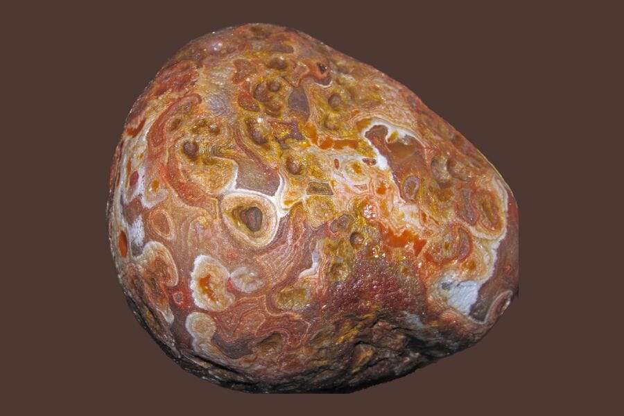 A mix of orange, red, brown, and white Agate against a brown background