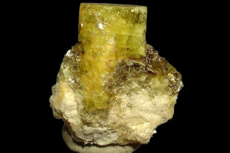 A beautiful yellow green Beryl against a black background