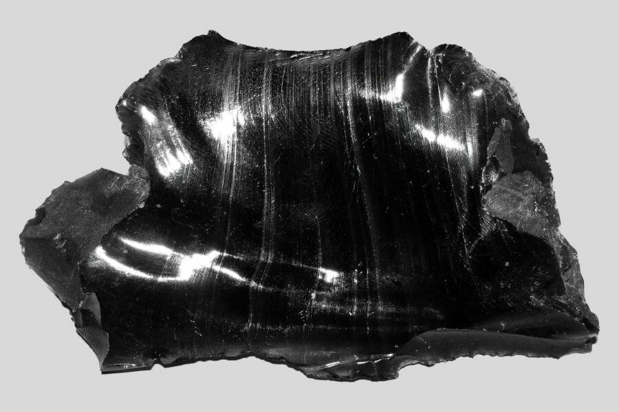 A shiny, black Obsidian against light gray background