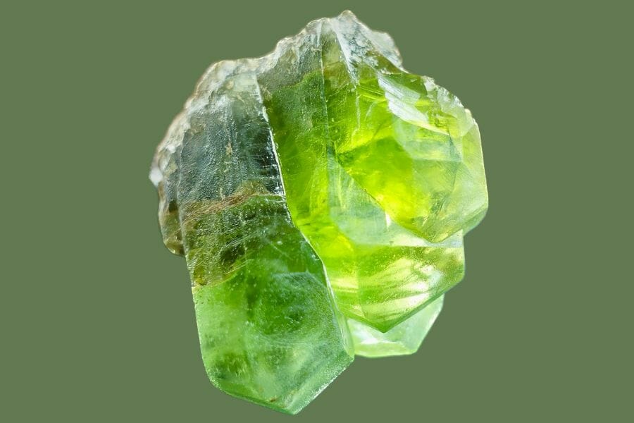 A translucent green Peridot against a light green background