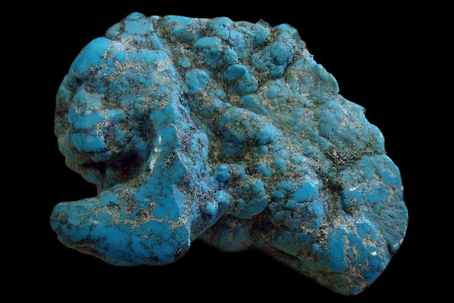 A huge bright blue Turquoise against black background