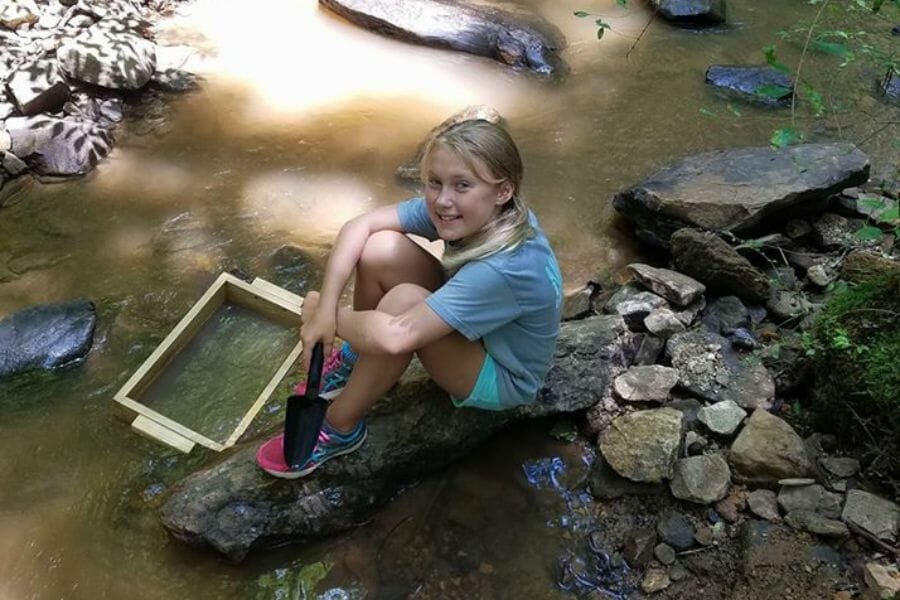 A kid enjoying looking for gem at the Emerald Hollow Mine