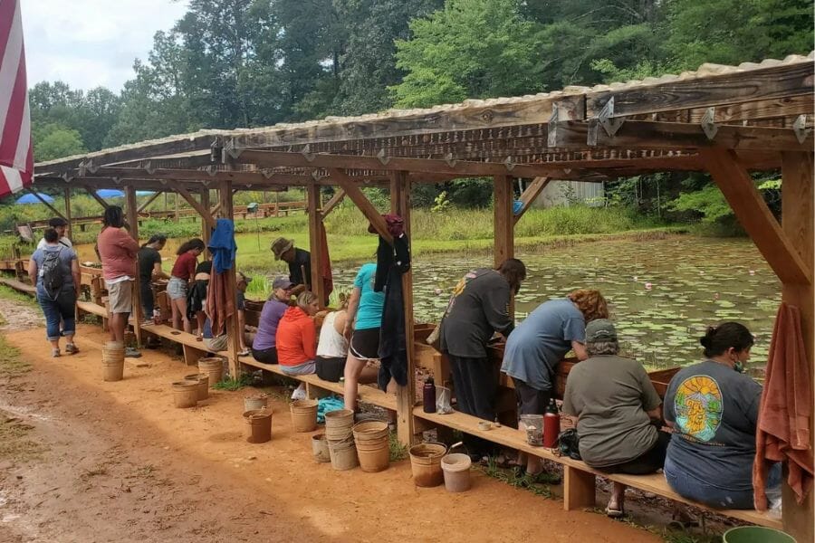 Adults line up seated to find gemstones at the Sheffield Gem Mine