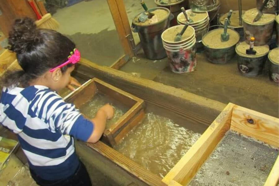 A kid looking for gems at Pigeon Forge Gem Mine