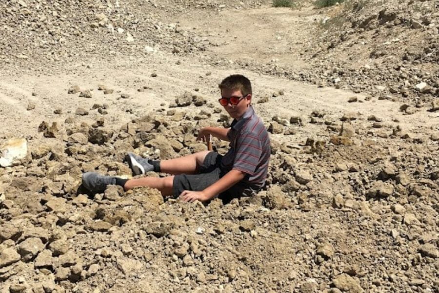 A kid searching for gems at Rainbow Ridge Opal Mine