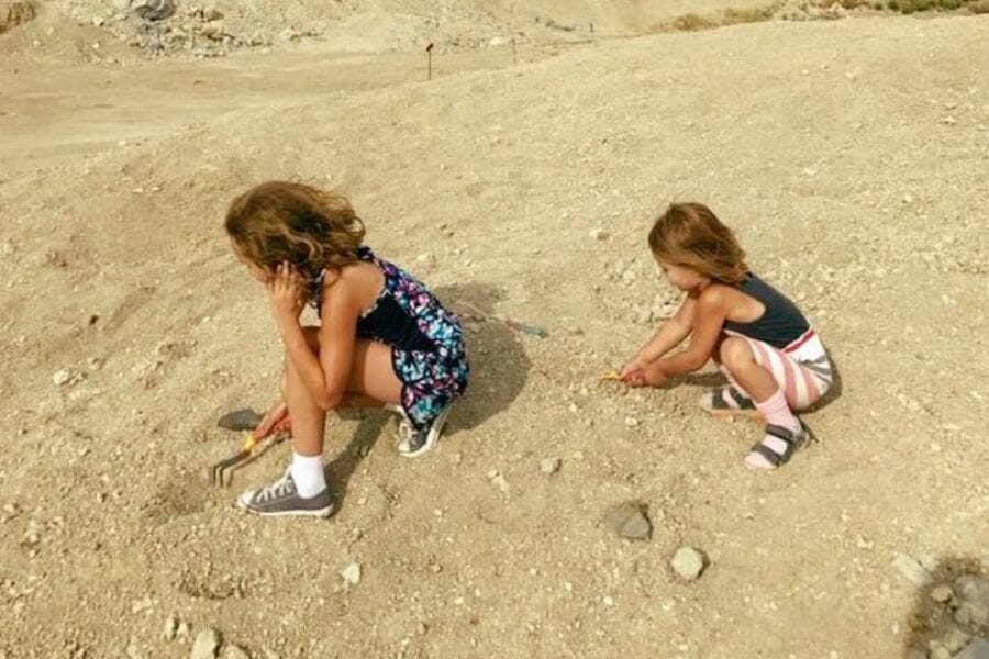 Two girls digging for gems at Royal Peacock Opal Mine