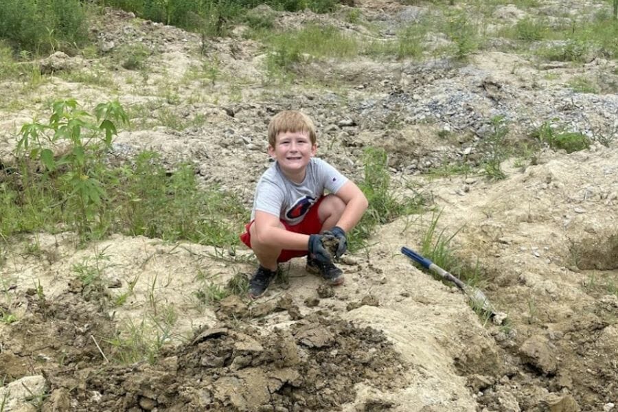 A kid digging for gems at Sheffler Rock Shop