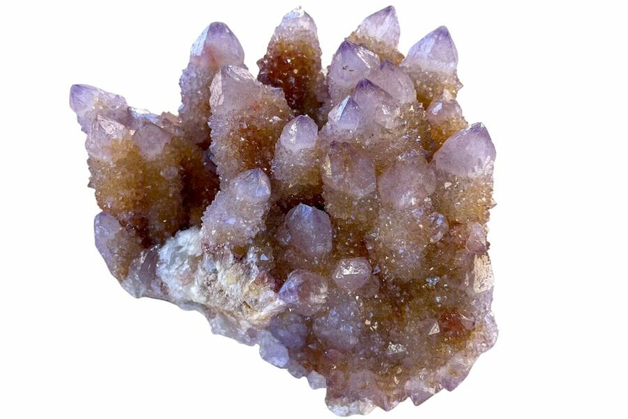 A purple Amethyst glimmering atop a rock