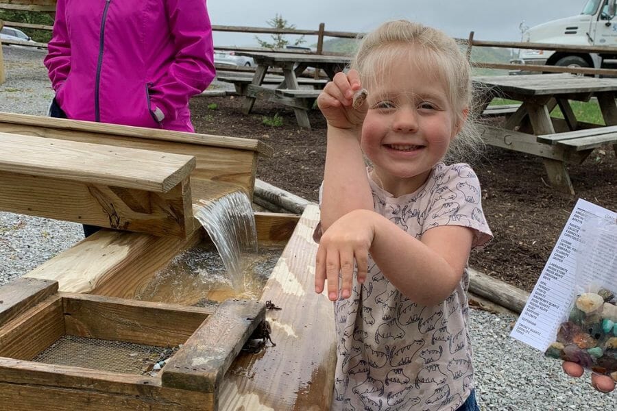 A little girl playfully shows the gemstone she found at the sluice of Seneca Caverns