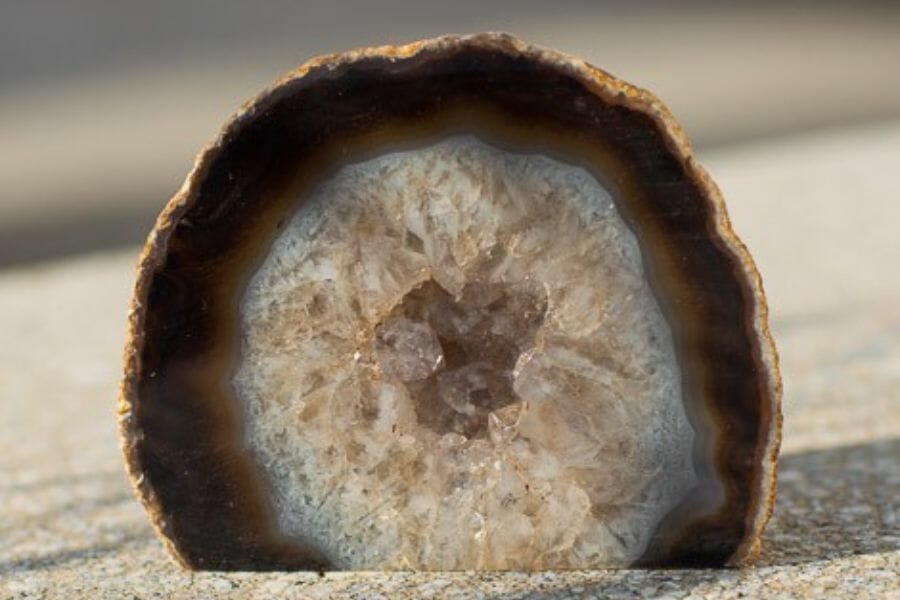 A gorgeous agate geode with different brown hues on a flat surface