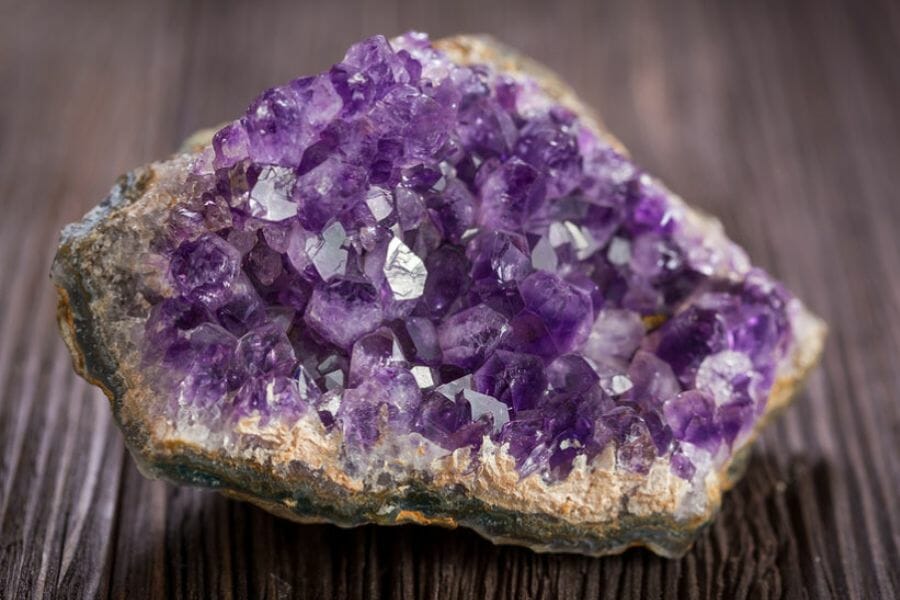 A stunning amethyst geode on a wooden table