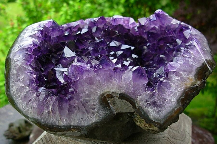 A mesmerizing big amethyst geode on a log