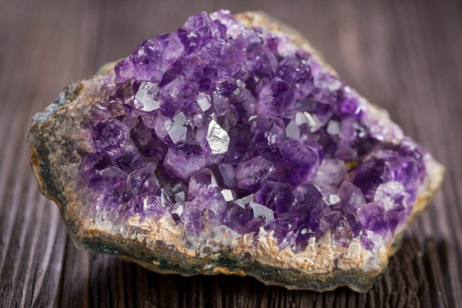 A gorgeous amethyst geode sitting on a wooden surface
