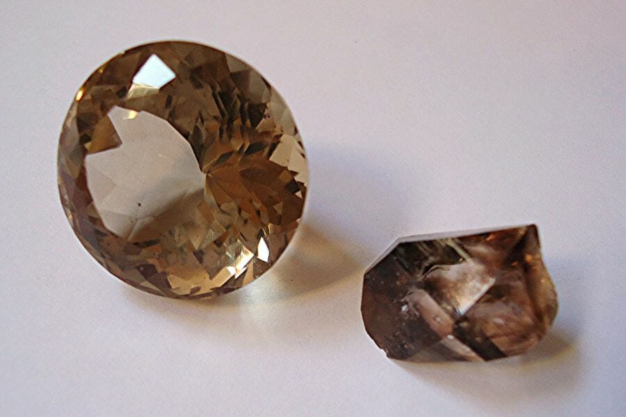 Two pieces of brown Smoky Quartz, one that's uncut and one that's polished