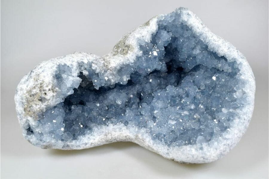 A gorgeous celestite geode surrounded with white crystals