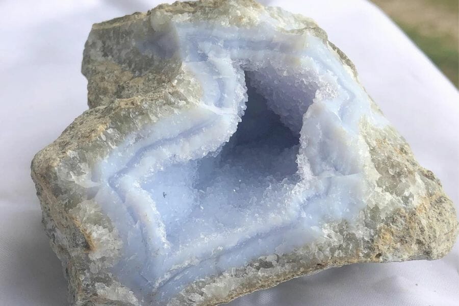 An elegant chalcedony geode with sparkling crystals and different blue hues