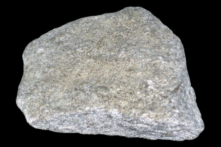 A big piece of gray Limestone against a black background