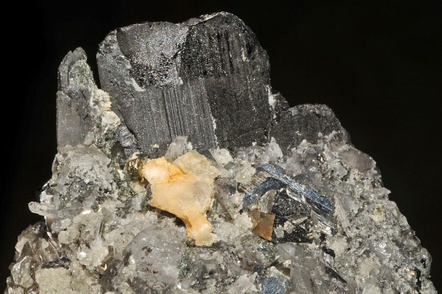 A seemingly grainy gray Wolframite atop a rock