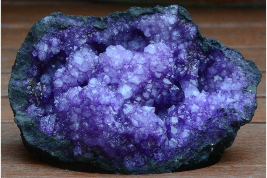 A beautiful piece of Amethyst geode on a wooden surface