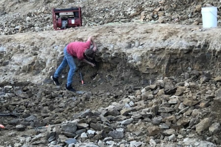 A man in red shirt looking for geodes at the Keokuk Geode Beds