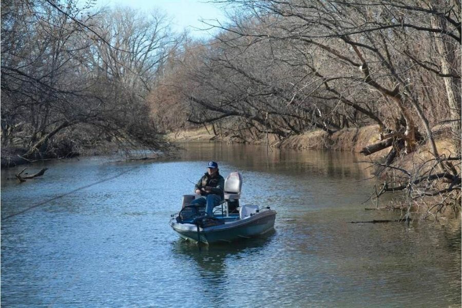 A man on a boat at Cottonwood Creek