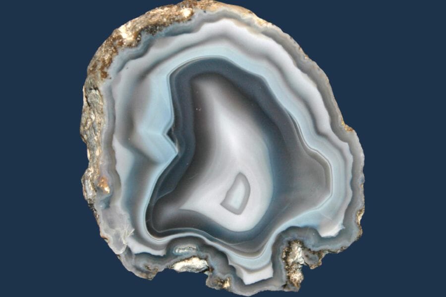 A cut open Agate geode with dark blue background