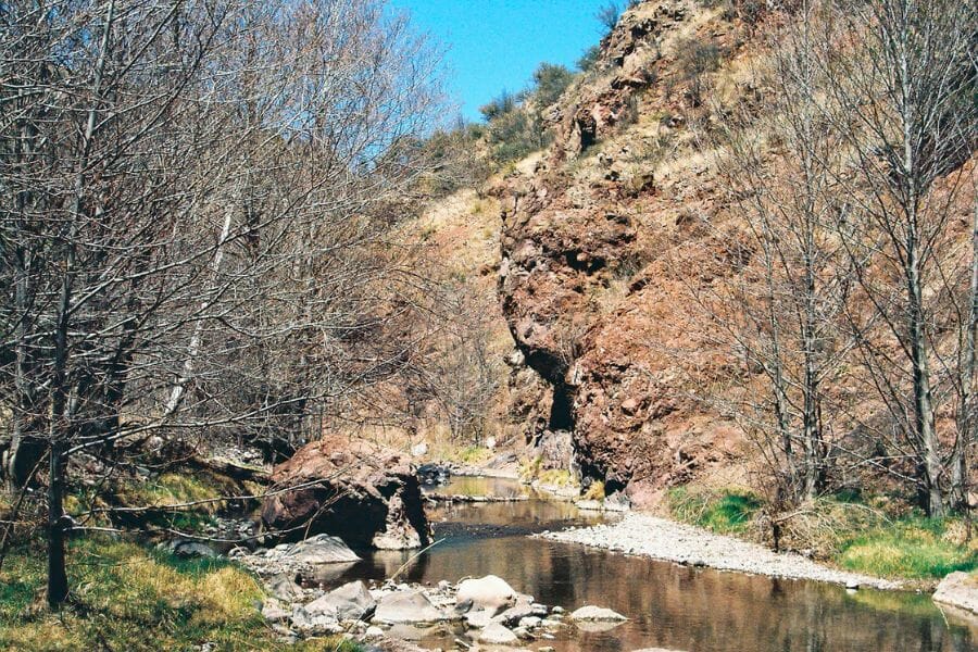 A scenic view of the Sapillo Creek and its surrounding formations