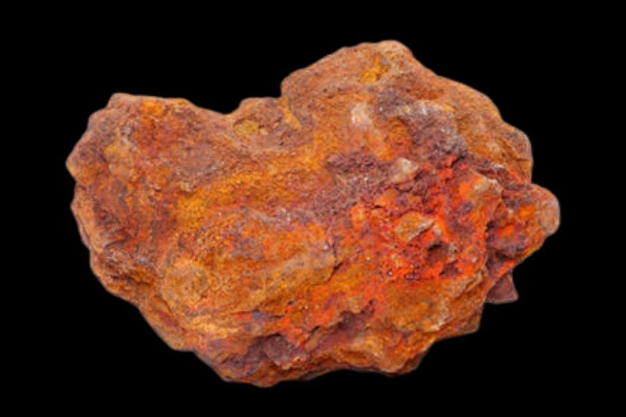 An orange Iron Ore with varying intensity of color on a black background