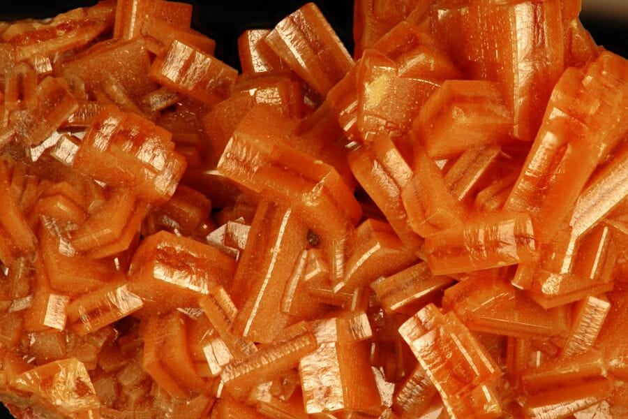 A detailed look at the shiny crystals of orange Wulfenites