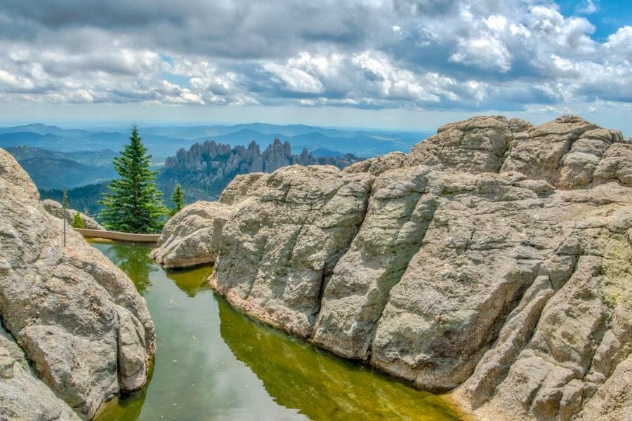 A beautiful view of big boulders with a creek at Pennington County