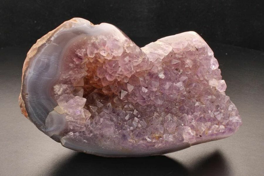 A unique pink geode with purple hue crystals