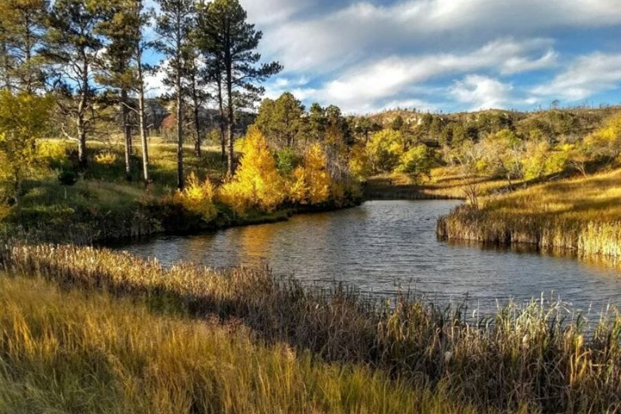 A scenic view of a river with trees and hills at Sioux County