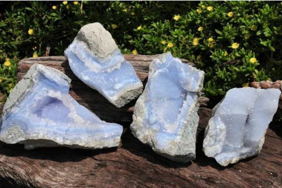 Four stunning chalcedony geodes sitting on a rock