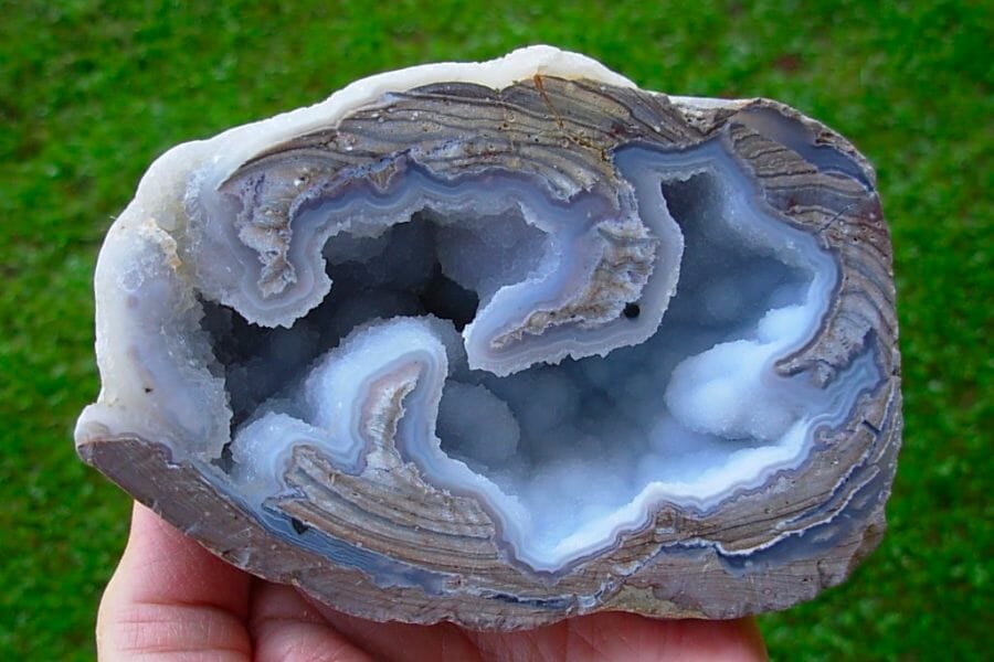 An amazing sample of an open Dugway geode with green grass as background