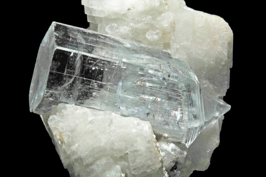 A transparent, clear Goshenite attached to a quartz