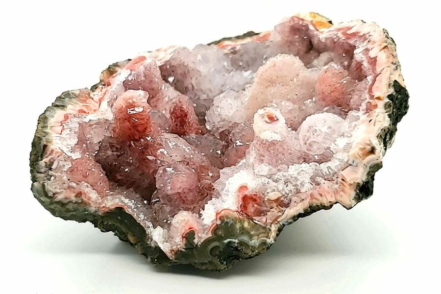 A cracked open geode showing its captivating pink crystals