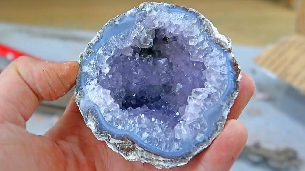 A tiny chalcedony geode with blue and purple crystals
