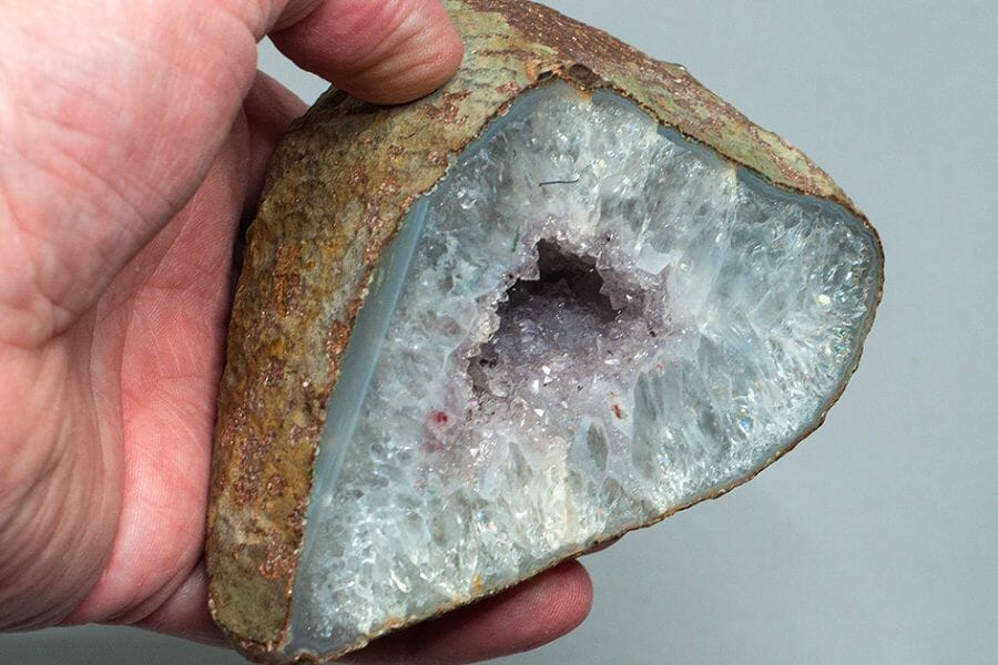 A cracked open Quartz-lined geode with Amethyst crystals