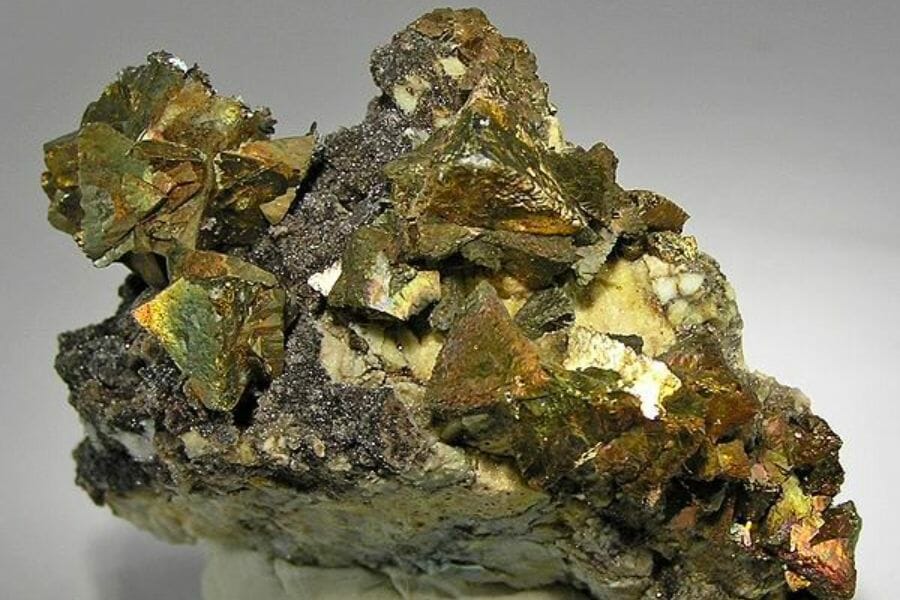 A piece of shiny, gold Chalcopyrite crystals