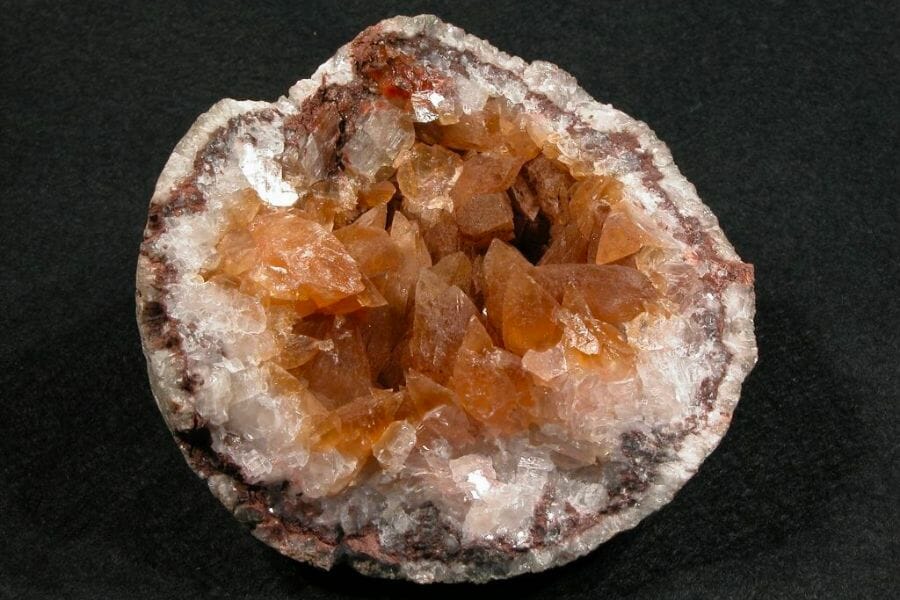 A beautiful sample of an opene geode showing orange and white crystals