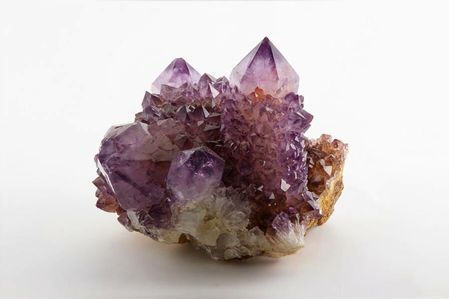 A chunk of purpley-brown Amethyst, uncut, with different sizes of crystals all over.