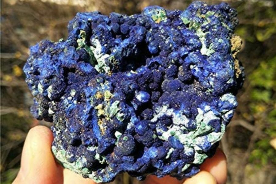 A beautiful azurite with patches of white, green, and blue hues and a bubble-like surface